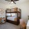 Large well lit bedroom with plush carpets and large windows 