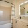 Three-Bedroom Homes for Rent in Natomas, CA - Tanzanite - Bathroom with Quartz Countertop, Shower with Tub, and Wood-Tone Cabinets.