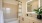 Three-Bedroom Homes for Rent in Natomas, CA - Tanzanite - Bathroom with Quartz Countertop, Shower with Tub, and Wood-Tone Cabinets.