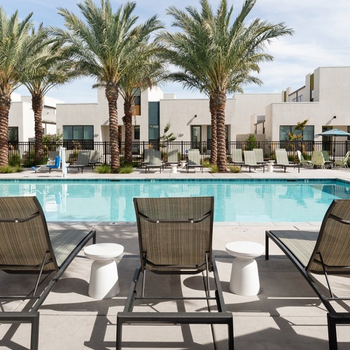 Shimmering resort-style pool Resort-style swimming pool with lounge seating
