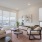 1-BR House In Natomas, CA - Tanzanite Homes - Spacious, Well-Lit Living Room With Modern Wood Style Flooring, Area Rug, Couch, Coffee Table, Armchair, Storage Cabinet, And Multiple Windows.