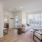 living room with large windows a couch and coffee table