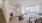 living room with large windows a couch and coffee table