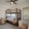 a room with a bunk bed and desk with a chair