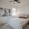 bedroom with a large bed, chair and window