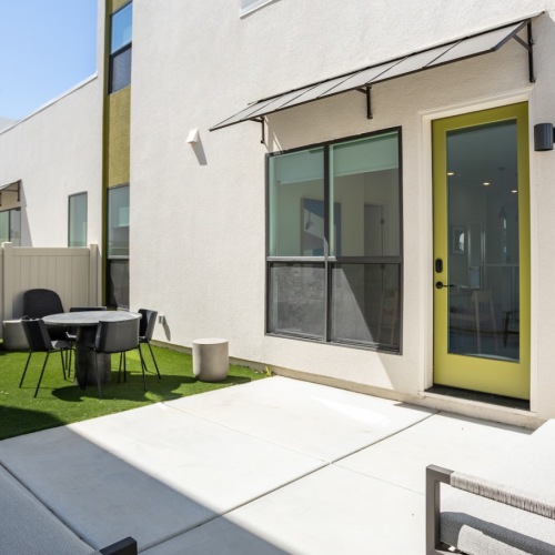 Spacious patios patio with a table, chairs and a couch