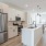 2-BR House In Natomas, CA - Tanzanite Homes - Stainless Steel Kitchen With Efficient All-Electric Appliances, Modern Wood Style Flooring, Quartz Countertops, Hardwood Cabinets, And Kitchen Island.